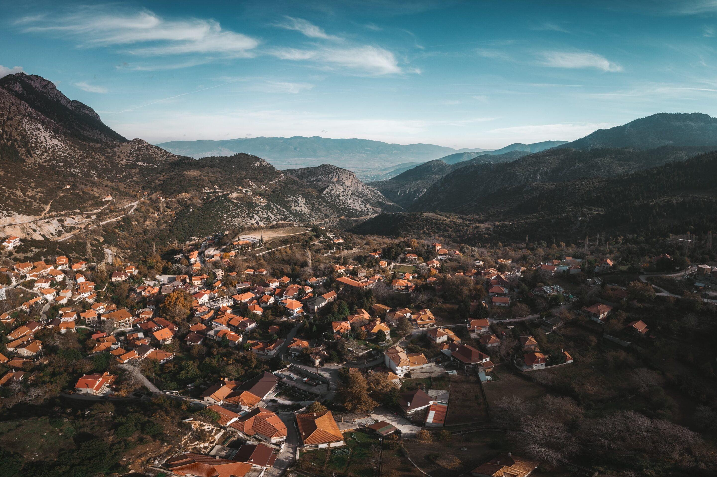 aerial photography of village surrounded by mountains